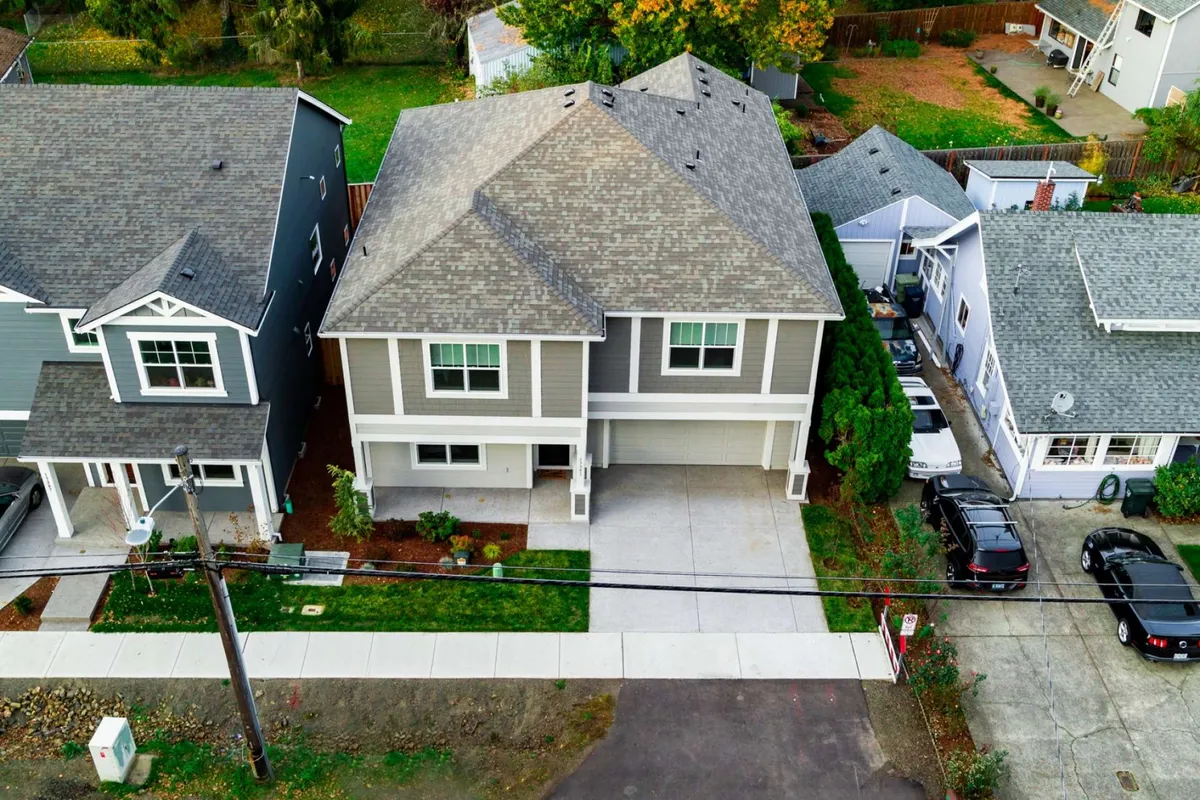 This exterior image captures the main entrance of Alexander Villa, with a driveway, lush surrounding greenery, and a welcoming facade. The setting suggests a family-friendly environment and serves as a visual representation of the villa as a comfortable home base.