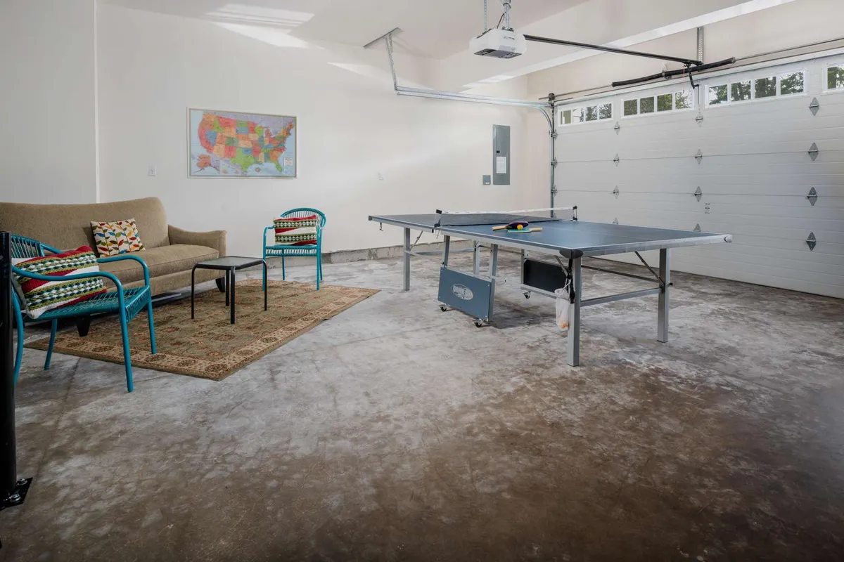 A dedicated game area with a ping pong table takes center stage, complemented by a casual seating area and a map on the wall, fostering a playful and relaxed atmosphere.